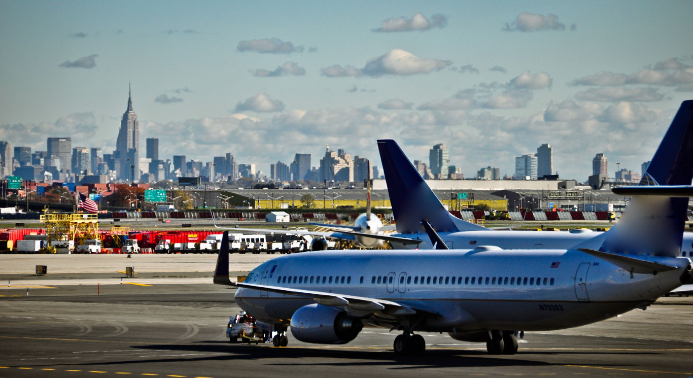 Plane on the Newark Airport tarmac with the New York City skyline in the background