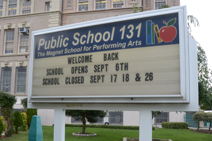 A public school sign that says Welcome Back along with dates when the school opens and closes